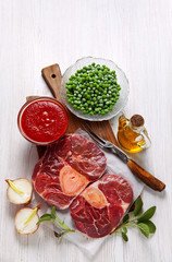 Raw fresh cross cut veal shank and Ingredients for making Osso B