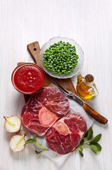 Raw fresh cross cut veal shank and Ingredients for making Osso B