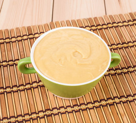 Pea soup in a green bowl.