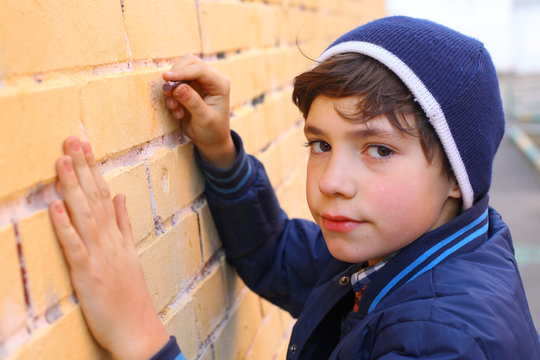 preteen handsome boy try himself as a graffiti artist on the yel