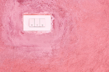 Old Switch on pink cement wall