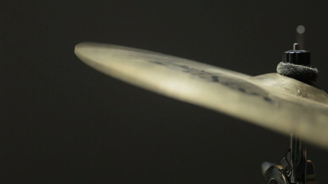  Cymbal crash hit, closeup slow motion. Black background.