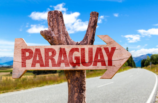 Paraguay wooden sign with road background