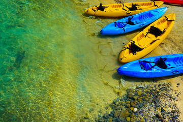 Canoe boats on a sunny beach - Powered by Adobe