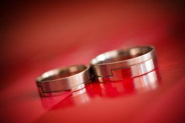 Isolated wedding rings with red background