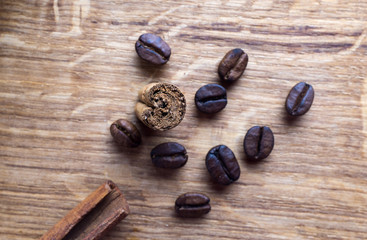 Coffe beans, cardamom and cinamon on wooden desk