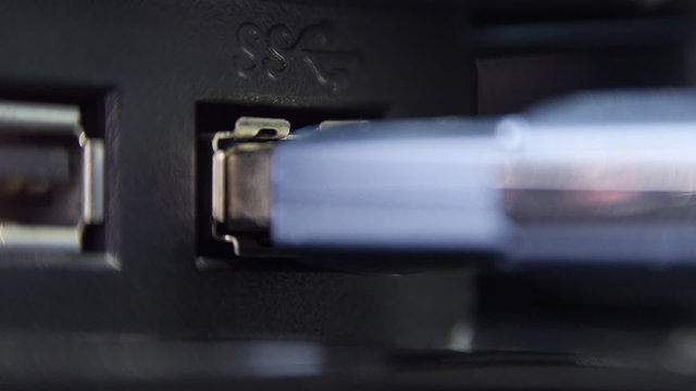Inserting usb flash drive into computer and pull out. 