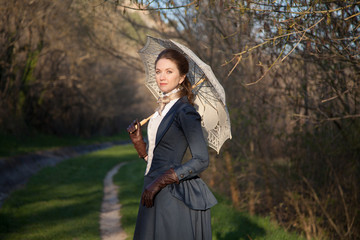 Romantic portrait of young beautiful lady outdoors