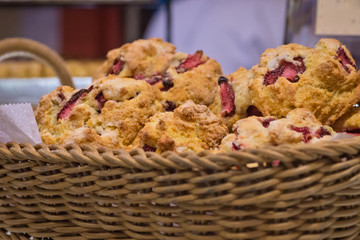 Lined straw basket filled with strawberry scones and others