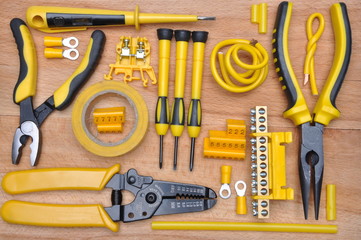 Top view of tools for electrical installation on wooden board