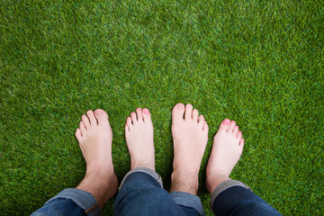 Couple mixed legs standing together on grass