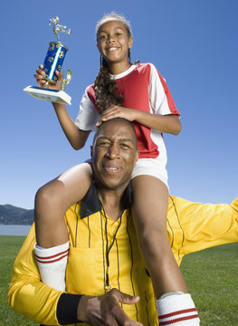 Mixed Race Girl On Soccer Coach's Shoulders