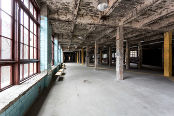 abandoned industrial interior with hall and big windows