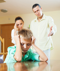 Fototapeta premium Ordinary family of three with teenage son having conflict