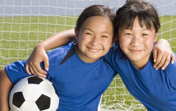 Fototapeta Multi-ethnic girls with soccer ball