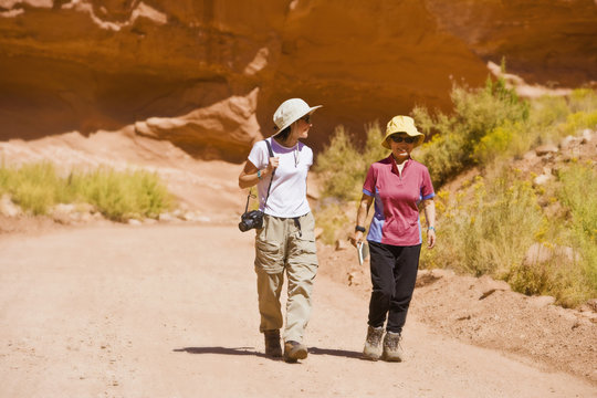 Asian women walking in desert