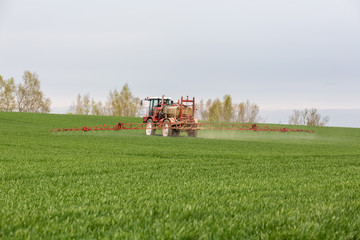 Fototapeta na wymiar Spraying the herbicides on the green field