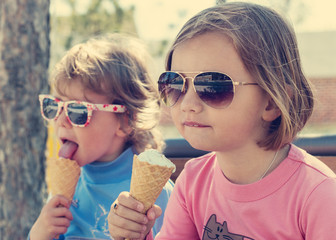 Two little girls eating ice cream.