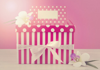 Feminine pink and white gift with greeting card.