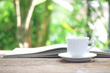 Notebook  and coffee cup on wooden table