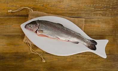 Rainbow trouts on a white cutting board.