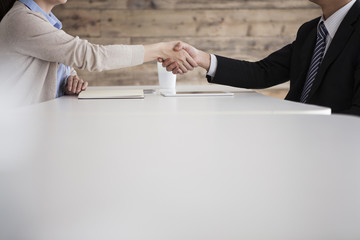 Men and women are shaking hands