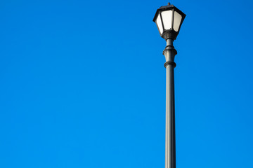 Fototapeta na wymiar Retro street lamp on the blue background