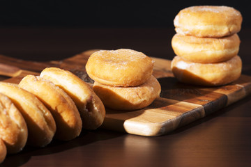 Group of fresh baked cinnamon donuts with raspberry jam. 