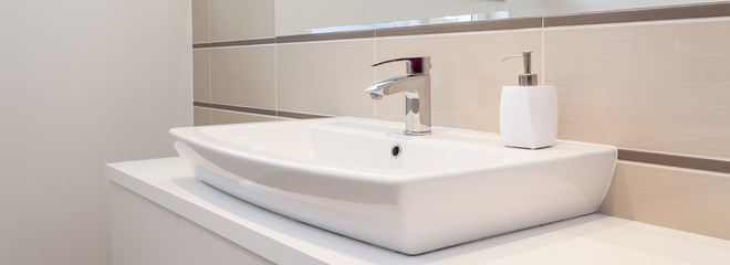 Fototapeta na wymiar Silver tap in elegant bathroom