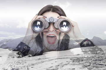 Double exposure of girl looking through binoculars and mountains
