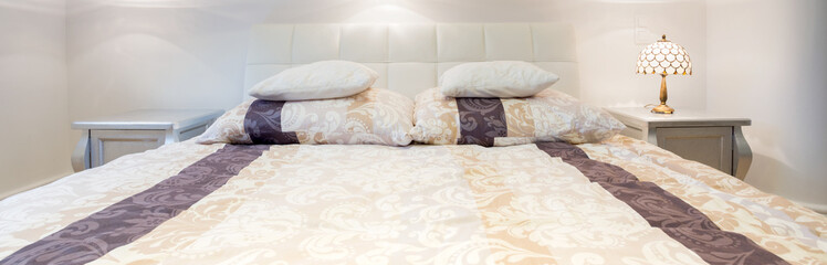 Fototapeta na wymiar Elegant double bed in bedroom