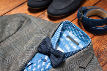 Men's suit, belt and footwear on a wooden background © golubovy