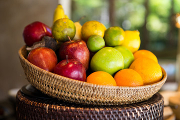 basket of fresh ripe juicy fruits at kitchen