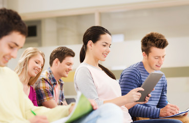 group of smiling students with tablet pc