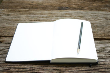 Fototapeta premium Notebook on wooden table