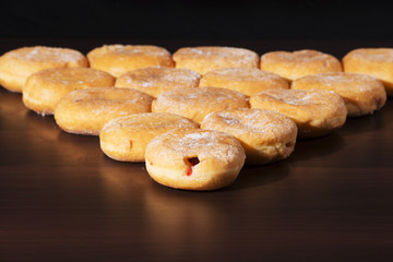Group of fresh baked cinnamon donuts with raspberry jam. 
