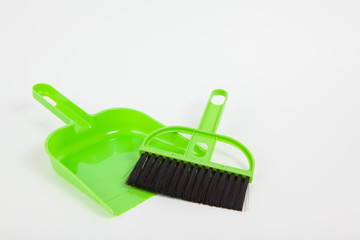 Garbage scoop and broom on white paper background