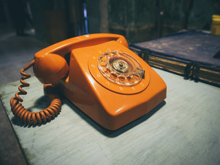 Vintage Retro phone orange color on table