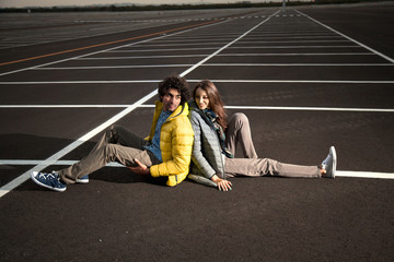 traveling couple sitting on an infinite road
