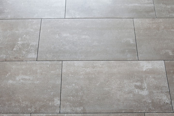 Grey floors with large tile horizontally