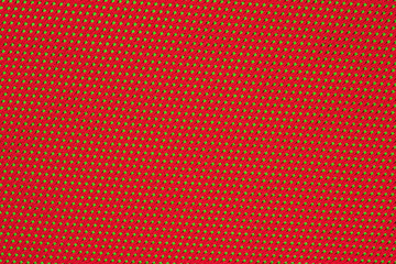 Red crumpled nonwoven fabric on a green