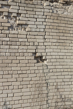 image of an old brick wall with a crack © nik_gru