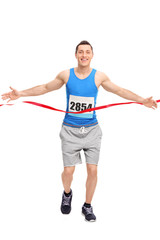 Male runner crossing the finish line