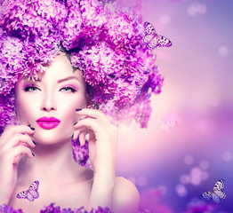 Beauty fashion model girl with lilac flowers hairstyle