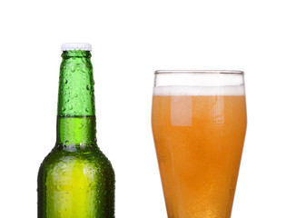 Chilled green bottle with condensate and a glass of beer lager 