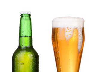 Chilled green bottle with condensate and a glass of beer lager 