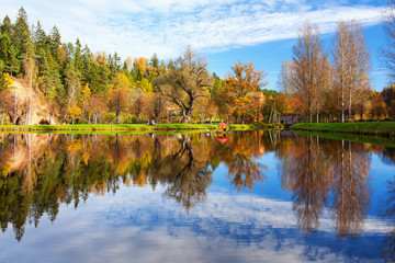 House for swans on the lake in the autumn forest