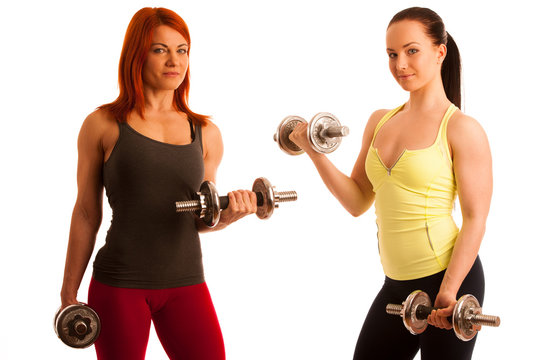 Beautiful young woman working out with dumbels in fitness gym