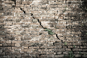 Cracked brick wall - Deep crack in a brick wall - toned image