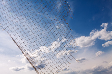 Fish net on blue sky with clouds